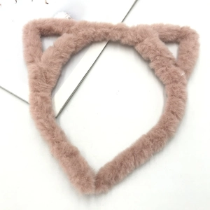 Close-up of soft plush cat ear headband in dusty rose showing fuzzy texture and cute design