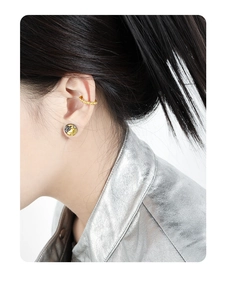 Close-up of S925 silver lava texture stud earring and gold ear cuff on a female model