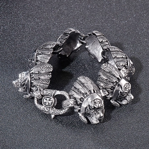 Close-up of vintage wolf head and feather links on an antique silver steel bracelet