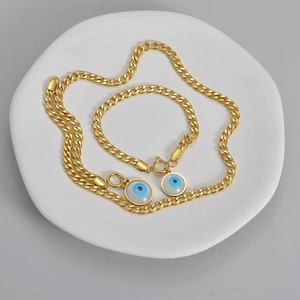 Golden stainless steel Cuban chain jewelry set with blue evil eye pendant for women