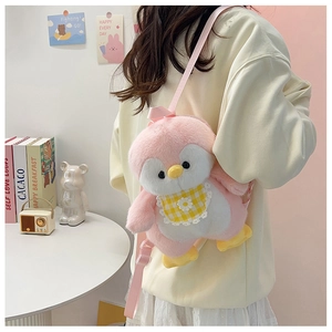 Rear view of a pink plush penguin backpack worn by a model in a warm indoor setting