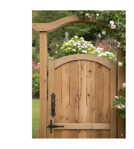 Detail of vintage black cast iron handle on a natural wooden garden gate with metal hinges
