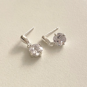 Macro shot of S925 sterling silver four-claw stud earrings with clear cubic zirconia