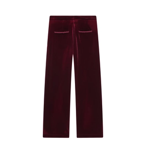 Detail view of burgundy velvet trousers showing back pockets and glossy fabric texture
