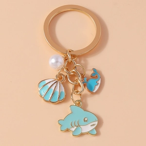 Detailed shot of ocean-themed keychain with whale tail, starfish, and pearl pendants