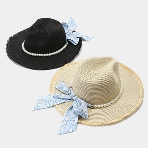 Lafia straw sun hat with pearl band, floral bow, and frayed brim in black and beige