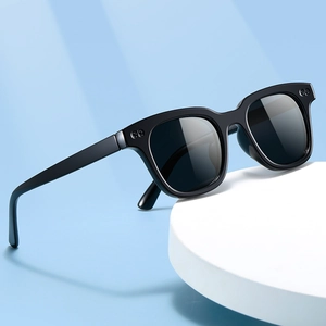 Stylish black frame sunglasses with dark lenses on a minimalist blue and white background