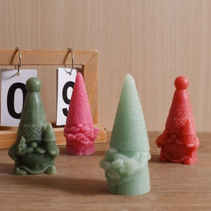 Christmas gnome scented candles with detailed snowflake relief patterns in four festive colors