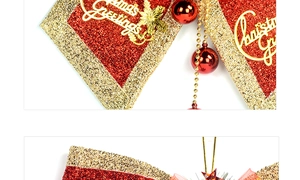 Detail of red and gold Christmas bow with sequins and Christmas Greetings metal tag