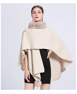 Detail of beige knitted shawl featuring soft faux rabbit fur collar and matching pom-poms