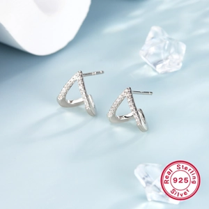 Detailed macro view of S925 sterling silver triangle stud earrings with pave zircon stones