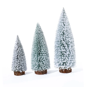Green mini Christmas trees with flocked snow effects and natural wooden bases on white