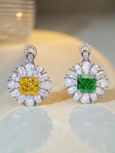 Macro shot of S925 silver flower pendants with yellow and green square cut gemstones