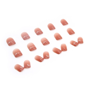 Pink gradient press-on nails with white hearts, cat paws, and pearl accents on white background