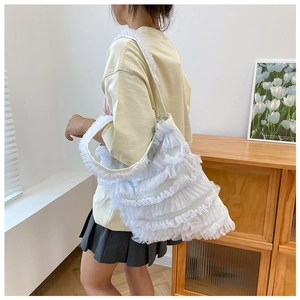 Detail view of the layered ruffle mesh texture on a white sweet fairy style tote bag