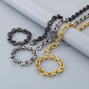 Detail of gothic square spike bracelets and skull necklaces in black, silver and gold metal