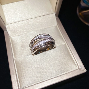 Macro shot of silver multi-layer crisscross ring featuring intricate pavé zircon settings