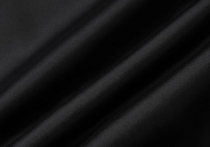 Close-up of premium black satin fabric texture with elegant folds and silky sheen