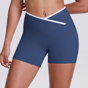 Detail of high-waisted navy yoga shorts featuring a white crossover V-shaped waistband
