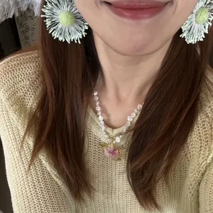 Handmade pearl necklace with pink flower pendant and woven white daisy stud earrings