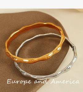 Macro detail of gold and silver bamboo style bangles with elegant metallic textures