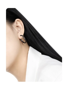 Detail view of matte black S925 silver irregular lava texture hoop earrings on model