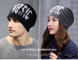 Detail shot of black and grey slouchy beanies featuring gothic music print for men and women