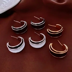 Chic gold-plated C-shaped enamel hoop earrings set in vintage minimalist aesthetic