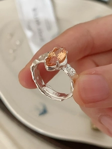 Detail of adjustable S925 silver ring with orange marquise-cut zircon gemstone