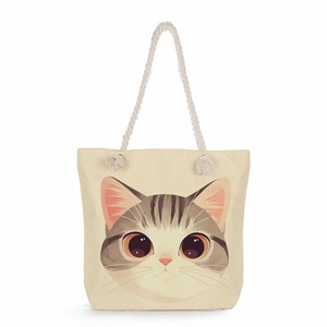 Detail of canvas tote bag with cartoon cat print and natural jute rope handles
