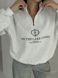 Detail of grey cotton sweatshirt featuring a half-zip collar and Lake Como graphic print