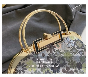 Close-up of vintage floral jacquard fabric with elegant golden metal ring handles