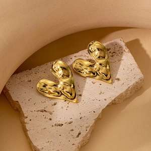 Minimalist 18K gold plated heart stud earrings with vintage lava texture on stone slab