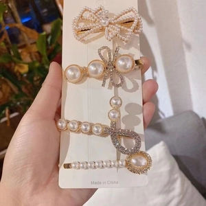 Detailed view of rhinestone pearl hair clips set featuring elegant bow and geometric designs