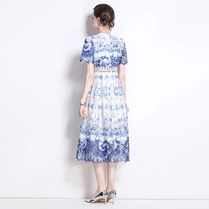 Back view of a midi lace dress with blue floral print and hollow out embroidery details