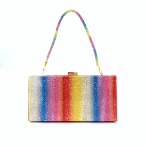 Detailed macro view of rainbow rhinestone clutch bag with gold clasp and chain strap
