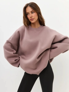 Detail of oversized crewneck sweatshirt in soft mauve with drop-shoulder texture
