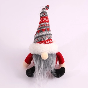 Christmas gnome plush ornament with red heart knitted hat and long grey beard on white background