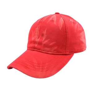 Detail of red tie-dye baseball cap featuring reinforced stitching and cotton twill texture