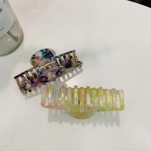 Detail of candy color cloud hair claw clips in marble and translucent resin styles