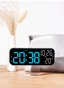 Macro shot of 9-inch LED alarm clock displaying blue digits, date and temperature