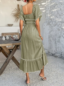 Detail view of olive green maxi dress with white ruffles and an open back design