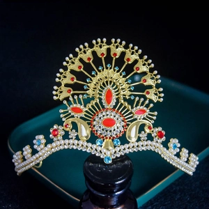 Luxurious gold crown with red blue gems and pearls in peacock feathers design
