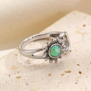 Macro shot of vintage sun ring with green opal stone and antique silver finish details