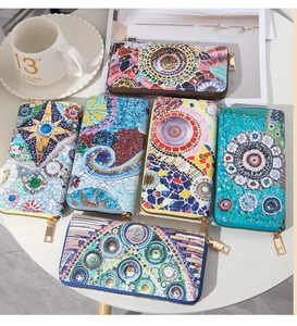 Detailed top view of various colorful geometric mandala pattern leather long wallets with zippers