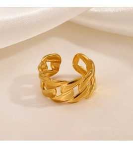 Macro shot of gold Cuban link chain ring on white silk, showing adjustable open band detail