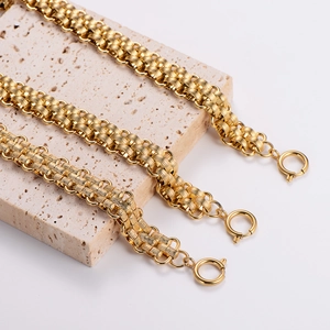 Three gold stainless steel braided bracelets displayed on beige stone with spring clasps