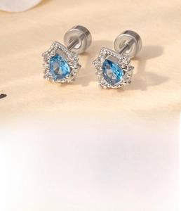 Detail view of water drop blue zircon stud earrings with double screw back in titanium steel