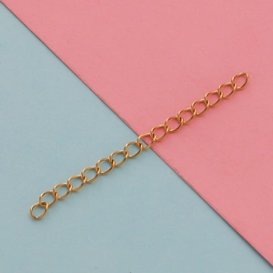 Close-up of golden stainless steel extender chain for necklaces and bracelets on blue background