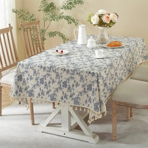 Blue floral linen tablecloth with fringe edges on wooden table for picnic decor